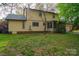 The backyard has mature trees, lush grass, and a screened in porch perfect for outdoor relaxation at 2131 Wildlife Rd, Charlotte, NC 28214