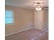 A bright bedroom featuring a ceiling fan, a window, and neutral carpet and walls at 2131 Wildlife Rd, Charlotte, NC 28214