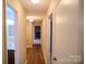 Hallway with wood floors leading to bathroom and living room at 2131 Wildlife Rd, Charlotte, NC 28214