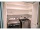 Bright laundry room with modern washer and dryer, and built-in shelving at 2131 Wildlife Rd, Charlotte, NC 28214