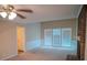 Spacious living room features a brick fireplace, large windows, and classic ceiling fan at 2131 Wildlife Rd, Charlotte, NC 28214