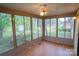Inviting sun room featuring wood floors, ceiling fan, and large windows with backyard views at 2131 Wildlife Rd, Charlotte, NC 28214