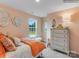 Cozy bedroom with peach walls, large window, stylish dresser and decorative wall art create a warm, inviting space at 2165 Trollinger Dr, Catawba, NC 28609