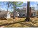 View of the backyard with a shed, wood pile, deck, and stepping stones at 2439 Heathershire Ln, Matthews, NC 28105