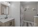 Cozy bathroom featuring shiplap walls, a stylish vanity, and a shower/tub combo providing a relaxing retreat at 2439 Heathershire Ln, Matthews, NC 28105