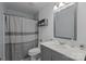 Cozy bathroom features a gray vanity, toilet, shower and neutral decor at 2439 Heathershire Ln, Matthews, NC 28105
