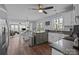 Bright kitchen with a center island, white cabinets, stainless appliances, and an open view to the Gathering room at 2439 Heathershire Ln, Matthews, NC 28105