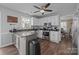 Open kitchen boasts white cabinets, stainless appliances, and a large center island at 2439 Heathershire Ln, Matthews, NC 28105