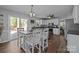 Eat-in kitchen features white cabinets, stainless steel appliances, and sliding glass doors at 2439 Heathershire Ln, Matthews, NC 28105
