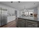 Open kitchen features white cabinets, stainless steel appliances, and a gray kitchen island at 2439 Heathershire Ln, Matthews, NC 28105