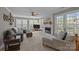 Bright living room features a fireplace, large windows, and comfortable seating at 2439 Heathershire Ln, Matthews, NC 28105