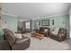 Spacious living room with leather furniture, neutral paint, and access to the dining area providing ample room to relax at 2439 Heathershire Ln, Matthews, NC 28105