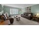 Comfortable living room with plush leather seating, a large window, and a relaxing atmosphere perfect for Gathering time at 2439 Heathershire Ln, Matthews, NC 28105