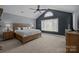 This main bedroom has a vaulted ceiling and a large window, offering plenty of natural light at 2439 Heathershire Ln, Matthews, NC 28105