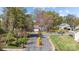 A charming home is nestled among mature trees and landscaping at 2439 Heathershire Ln, Matthews, NC 28105