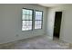 Bedroom with closet, two windows, and white walls at 2752 Bramble Ridge Ct, Charlotte, NC 28215