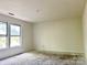 Bright bedroom featuring white walls, trim and two windows at 2752 Bramble Ridge Ct, Charlotte, NC 28215