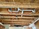 Close-up of exposed pipes and ceiling work above the kitchen cabinets at 2752 Bramble Ridge Ct, Charlotte, NC 28215