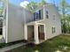 Two-story home featuring gray siding, stone accents, and a covered front porch at 2752 Bramble Ridge Ct, Charlotte, NC 28215