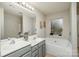 Bathroom with double sinks, a soaking tub, and a frosted window for privacy at 3009 Early Rise Ave, Indian Trail, NC 28079