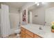 Bright bathroom featuring a shower-tub combo, a single sink vanity and a large mirror at 3009 Early Rise Ave, Indian Trail, NC 28079