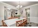 Elegant dining room with wood floors, chandelier, wainscoting, and seating for eight at 3009 Early Rise Ave, Indian Trail, NC 28079