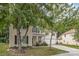 Two-story home with mature trees, a covered porch, and a driveway leading to a two-car garage at 3009 Early Rise Ave, Indian Trail, NC 28079