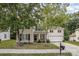 Two-story home with mature trees, covered porch, and a driveway leading to a two-car garage at 3009 Early Rise Ave, Indian Trail, NC 28079
