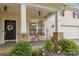 Cozy front porch with seating area, potted plants, and decorative welcome sign at 3009 Early Rise Ave, Indian Trail, NC 28079