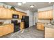 Well-equipped kitchen featuring wooden cabinets, granite countertops, and black appliances at 3009 Early Rise Ave, Indian Trail, NC 28079