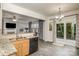 Open concept kitchen featuring wooden cabinets, tile backsplash, and stainless steel sink at 3009 Early Rise Ave, Indian Trail, NC 28079