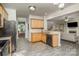 Well-lit kitchen showcases stone countertops, stainless steel appliances, and hardwood floors at 3009 Early Rise Ave, Indian Trail, NC 28079