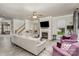 Comfortable living room with a fireplace, TV, hardwood floors, and two purple armchairs at 3009 Early Rise Ave, Indian Trail, NC 28079