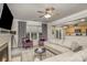 Open-concept living room with fireplace, ceiling fan, neutral furniture, and abundant natural light at 3009 Early Rise Ave, Indian Trail, NC 28079