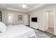 Well-lit main bedroom featuring a TV, walk in closet, and an ensuite bathroom with a soaking tub at 3009 Early Rise Ave, Indian Trail, NC 28079
