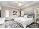 Spacious main bedroom boasting natural light, a ceiling fan, and a stylish neutral color palette at 3009 Early Rise Ave, Indian Trail, NC 28079