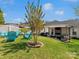 Charming backyard featuring an outdoor fireplace, seating area, and lush lawn for relaxation and entertaining at 3020 Salmon River Dr, Monroe, NC 28110