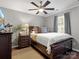 Comfortable bedroom features a ceiling fan, ample natural light, and a neutral color palette at 3020 Salmon River Dr, Monroe, NC 28110