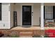 Charming front porch showcasing a decorative door, seating area, and colorful floral accents for a welcoming feel at 3020 Salmon River Dr, Monroe, NC 28110