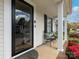 Inviting front porch featuring comfortable seating, a stylish door, and beautiful landscaping with vibrant flowers at 3020 Salmon River Dr, Monroe, NC 28110