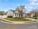 Attractive single-story home showcasing a lush green lawn, mature tree, and a welcoming front entrance at 3020 Salmon River Dr, Monroe, NC 28110