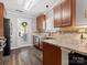 Well-lit kitchen with stainless steel appliances, granite counters, and dark wood cabinets at 3020 Salmon River Dr, Monroe, NC 28110