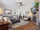 Inviting living room with a stone fireplace, a comfortable couch, and wood flooring at 3020 Salmon River Dr, Monroe, NC 28110