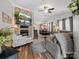 Open-concept living room featuring a stone fireplace, TV, and seamless flow to the dining area, perfect for entertaining at 3020 Salmon River Dr, Monroe, NC 28110