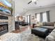 Open-concept living room featuring a fireplace and seamless flow to the dining area at 3020 Salmon River Dr, Monroe, NC 28110