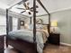 Spacious main bedroom suite with four-poster bed, ceiling fan, and neutral color palette at 3020 Salmon River Dr, Monroe, NC 28110