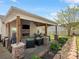 Beautifully designed covered patio featuring a stone fireplace, TV, and dining area, ideal for gatherings at 3020 Salmon River Dr, Monroe, NC 28110