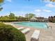 Community pool with lounge chairs and seating under blue skies at 3020 Salmon River Dr, Monroe, NC 28110