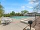 Community pool area offers lounge chairs, tables, chairs, and a grilling area at 3020 Salmon River Dr, Monroe, NC 28110