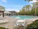 Inviting community pool area with comfortable seating, perfect for relaxing and enjoying the outdoors at 3020 Salmon River Dr, Monroe, NC 28110